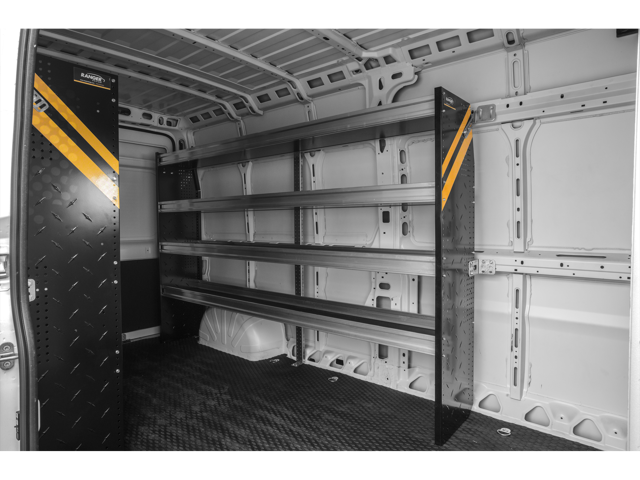 Interior cargo area of a van fitted with metal shelving units along the side wall