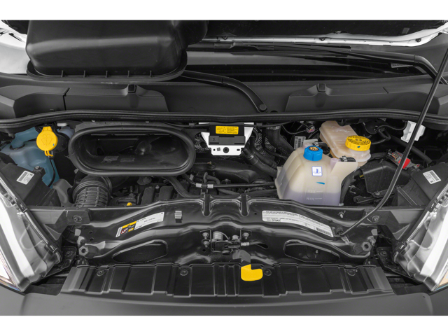 Engine bay of a cargo van with visible components including coolant reservoir