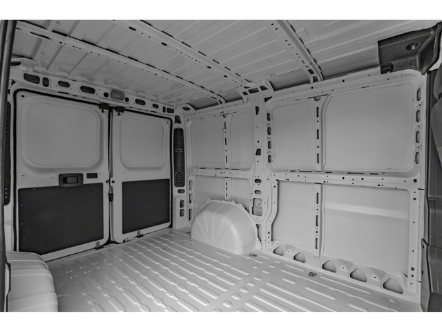 Empty cargo area of a white van with ribbed metal flooring