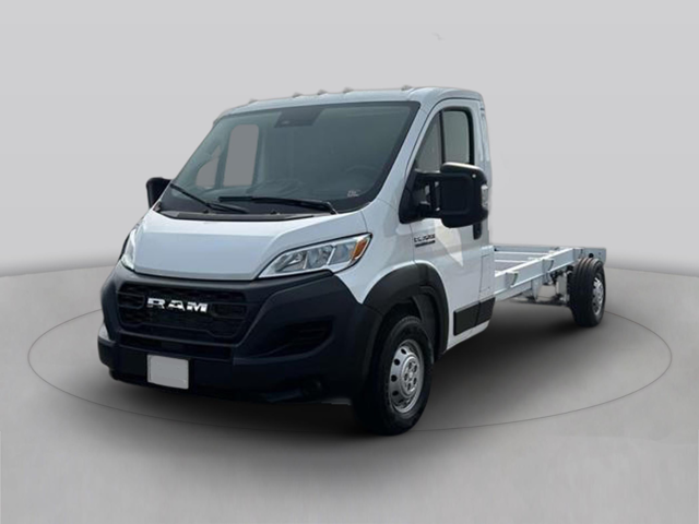 White chassis cab truck in front three-quarter view on a showroom platform