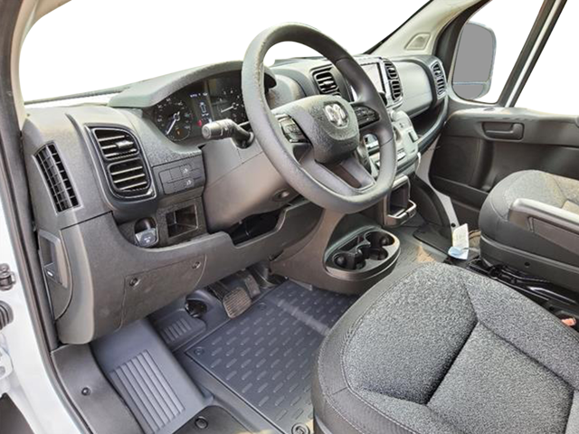 Vehicle interior showing steering wheel, dashboard controls