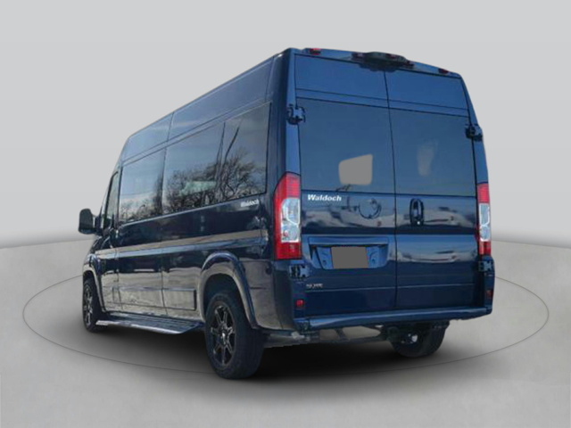 Rear view of a dark blue van with closed rear doors, taillights