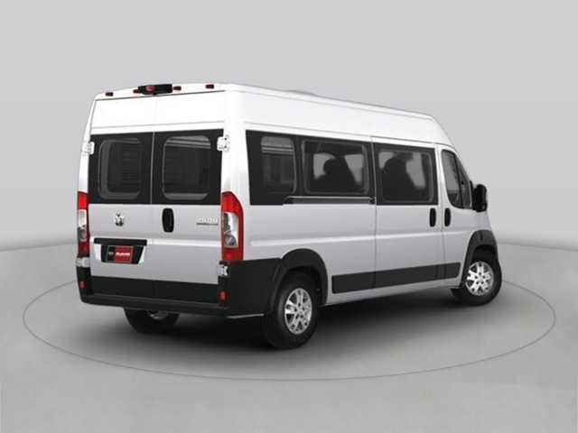 Rear three-quarter view of a white passenger van with side windows