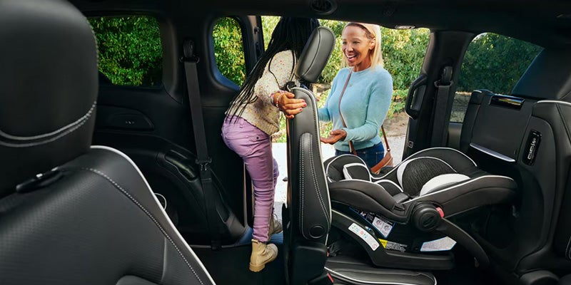 Rear interior of a minivan with a child car seat installed