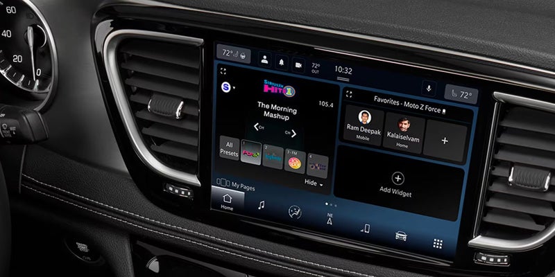 Close-up of a vehicle infotainment system displaying navigation and media