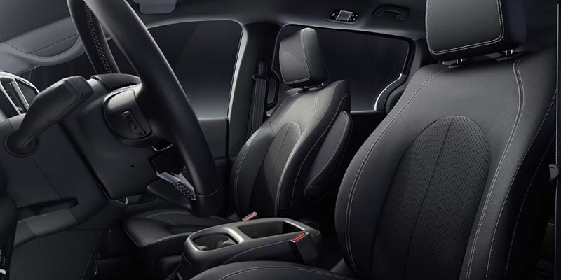Front interior seating area with black fabric seats, center console