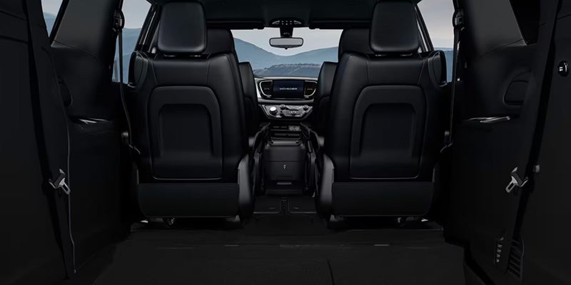 Rear interior of a minivan showing folded seats and open cargo space extending toward the front cabin