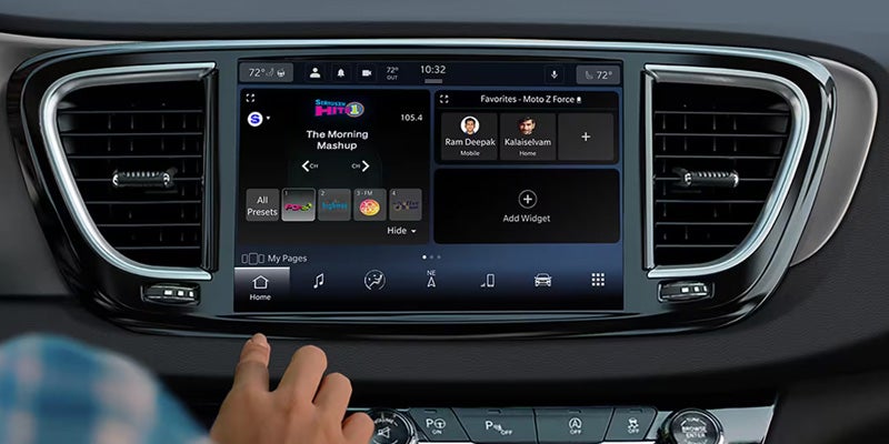 Close-up of a vehicle touchscreen infotainment system showing media controls