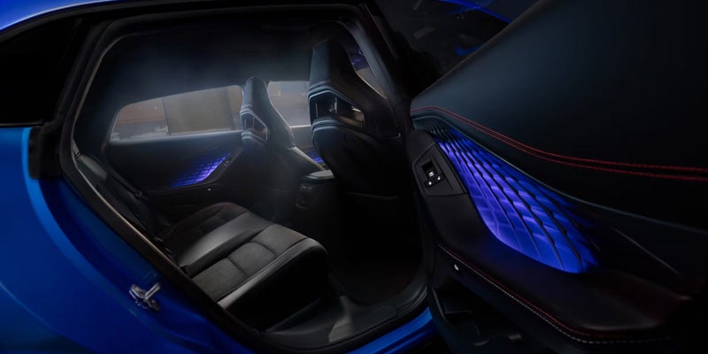 Close-up interior view showing car door panel with ambient blue lighting