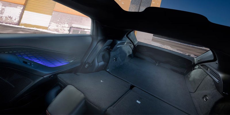 Rear interior cargo area with folded seats creating flat storage space