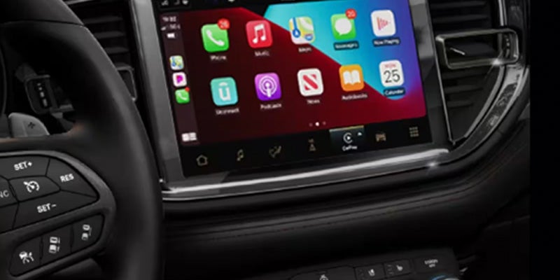 Close-up of a vehicle dashboard touchscreen displaying app icons