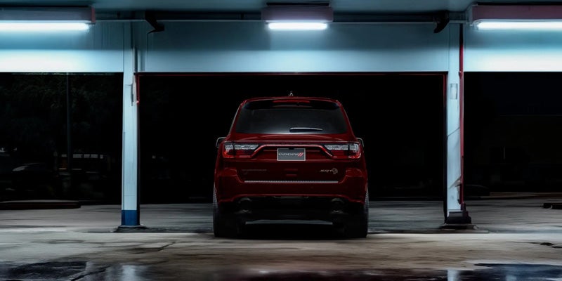 Red SUV parked inside a garage or covered structure