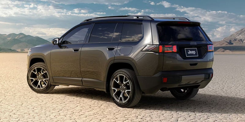 Gray SUV parked on a flat outdoor terrain, shown in rear three-quarter view