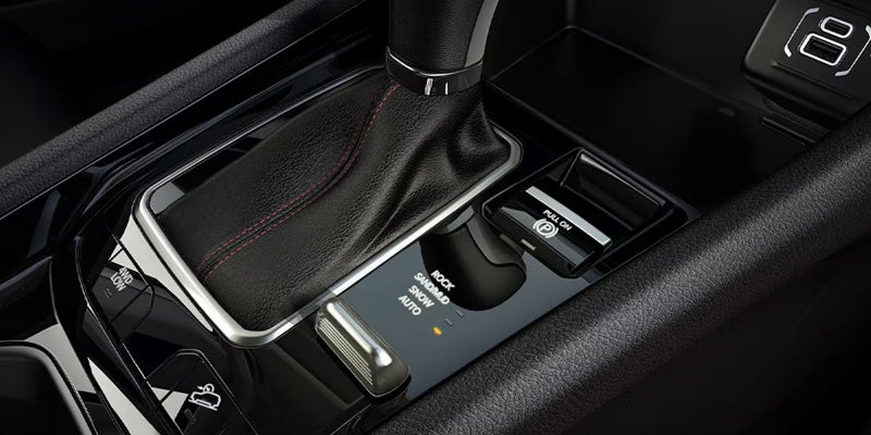 Close-up of center console showing gear shifter, drive mode selector