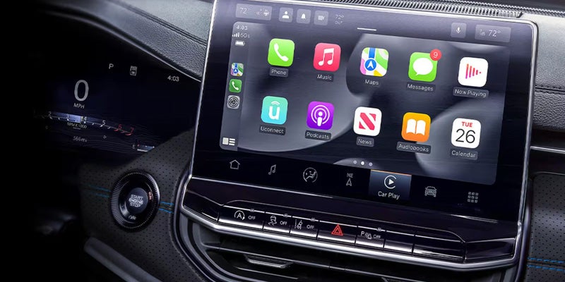 Close-up of dashboard touchscreen showing app icons, navigation