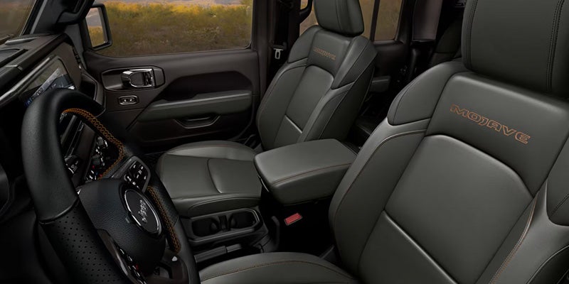 Front interior of a pickup truck with leather seats, center console, steering wheel