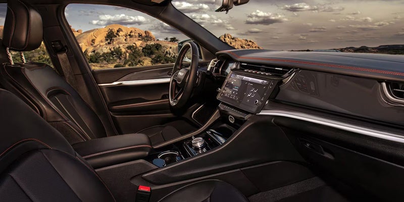 Front interior of SUV showing dashboard, touchscreen infotainment system