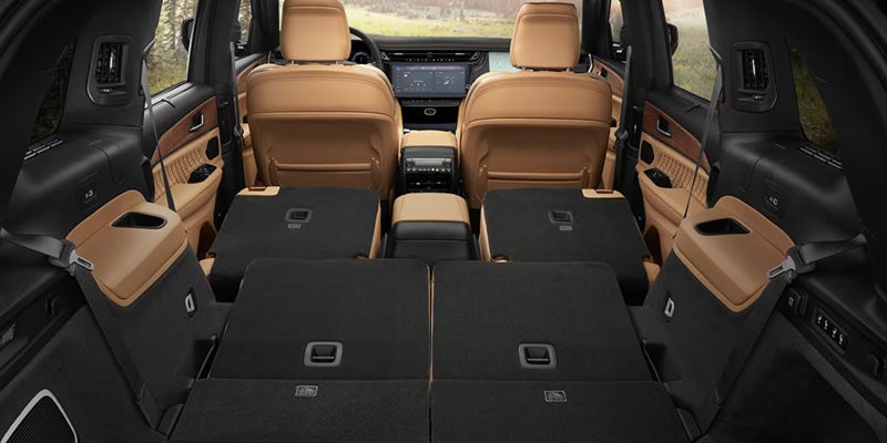 SUV interior showing rear seats folded flat to create a large cargo area