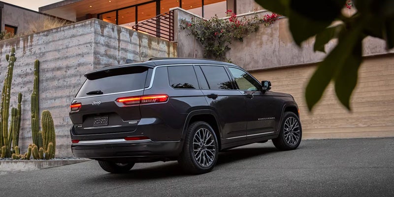Black SUV parked in a residential driveway beside a modern house