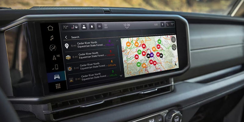 Dashboard touchscreen navigation system displaying trail maps