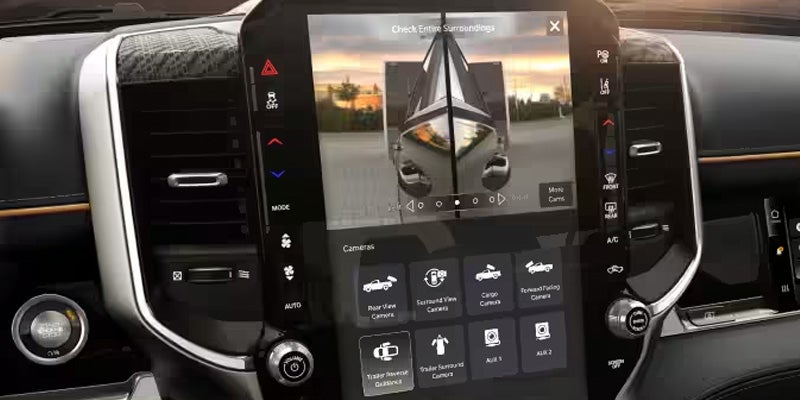 Close-up of a vehicle’s vertical touchscreen infotainment system displaying camera view