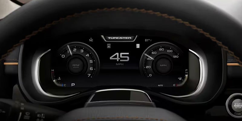 Close-up of a digital instrument cluster inside a vehicle displaying speed and driving information
