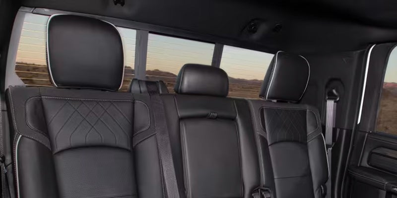 Rear passenger seats inside a RAM truck with black leather upholstery