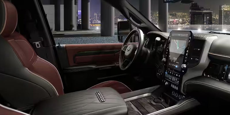 Interior view of a RAM truck cabin showing premium seats, steering wheel,
