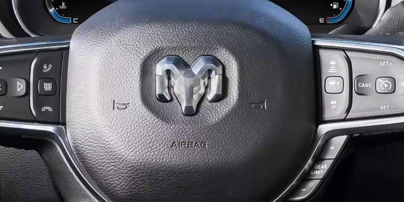 Close-up of a RAM steering wheel with logo and integrated control buttons