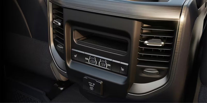 Rear seat console inside a truck showing air vents, USB ports